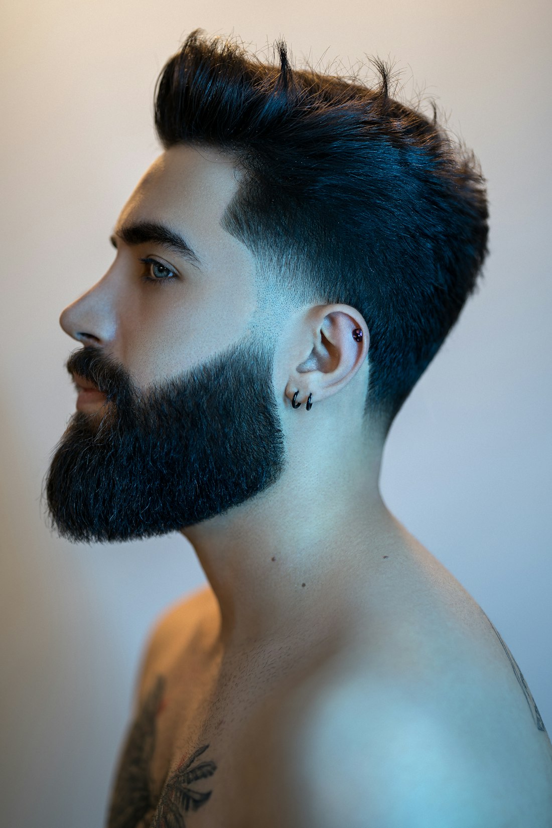 A sharp scissor cut and sculpted beard, studio profile
